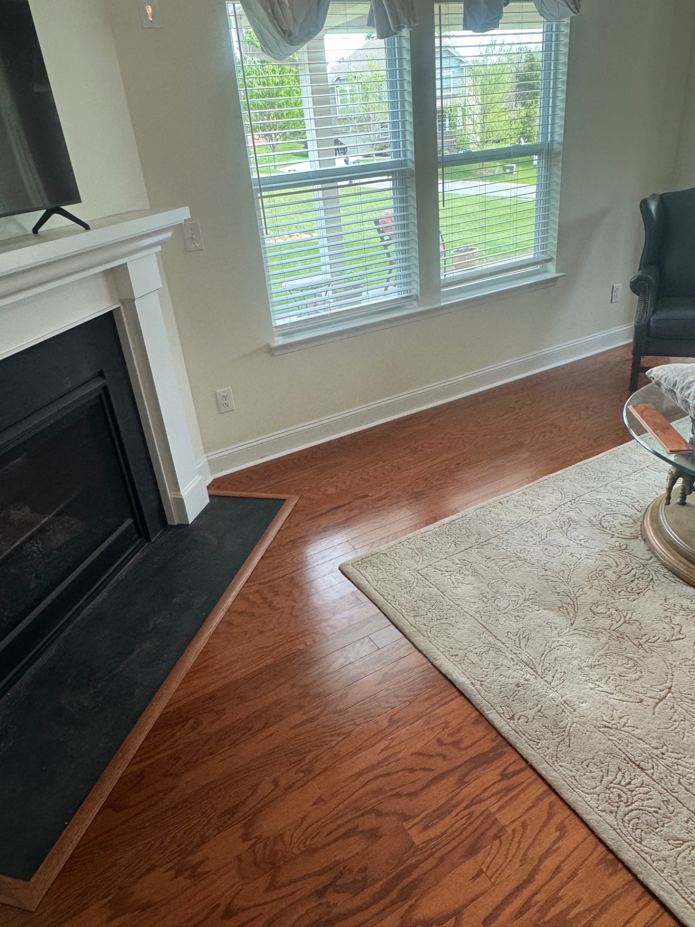 Refinished cherry oak hardwood in living room near fireplace